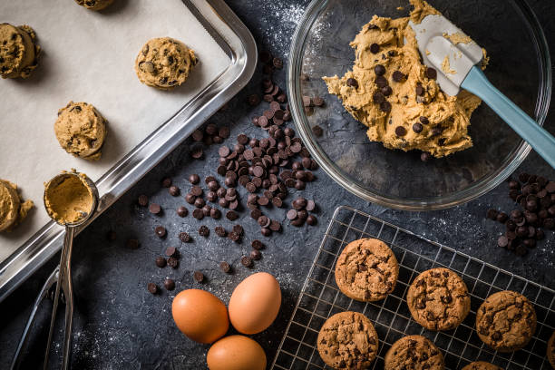 Chewy chocolate chip cookie dough balls prepared with baking soda ready for the oven.