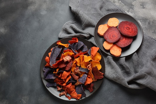 Colorful homemade vegetable chips made from beetroot and sweet potatoes.