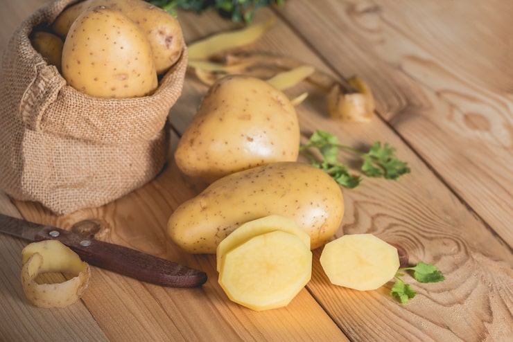 Slicing raw potatoes for Indian homemade chips recipes soaking in cold water to remove starch.