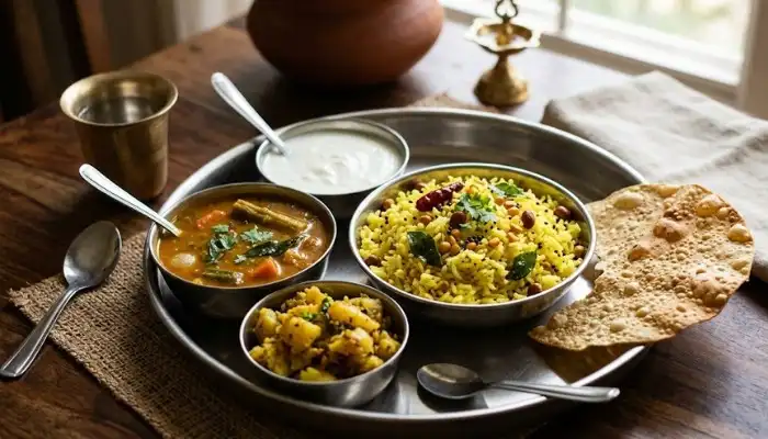 A complete South Indian meal featuring a bowl of lemon rice served with a side of thick vegetable sambar, plain curd, and roasted papad. A complete South Indian meal featuring a bowl of lemon rice served with a side of thick vegetable sambar, plain curd, and roasted papad.