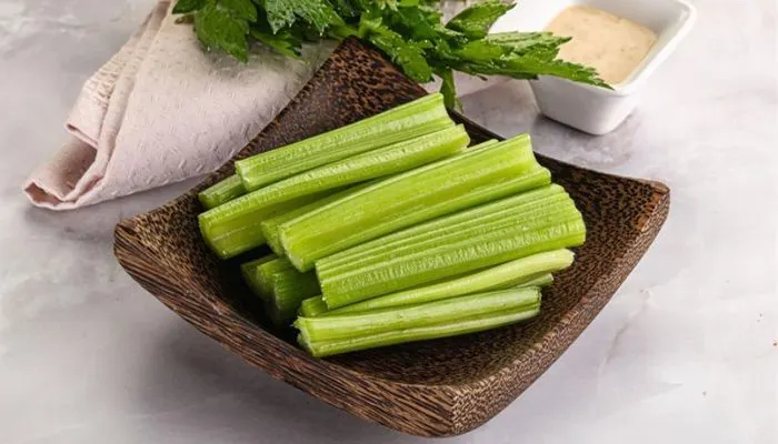 Fresh celery sticks being avoided as a late-night snack due to high water content.