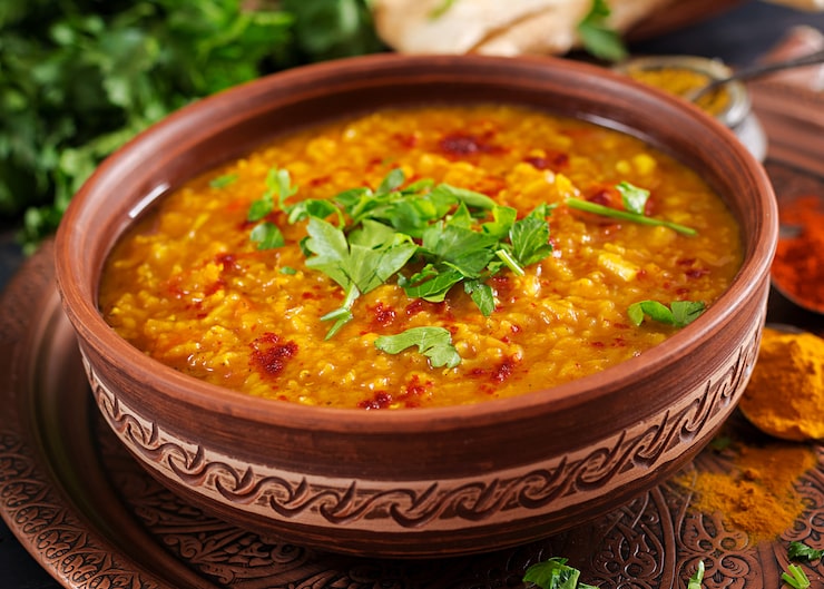 A bowl of flavourful and nutritious masoor dal with fresh coriander on top. A bowl of flavourful and nutritious masoor dal with fresh coriander on top.