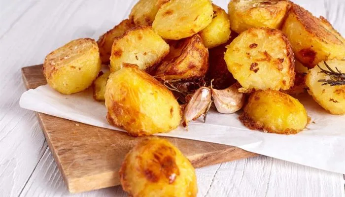 A cast-iron skillet filled with crispy, golden-brown roasted potatoes. A cast-iron skillet filled with crispy, golden-brown roasted potatoes.